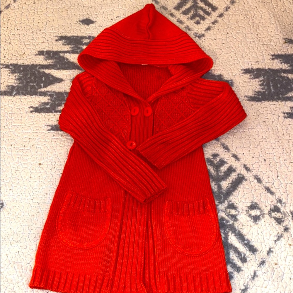 Red hooded knee length knitted sweater